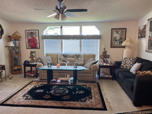 a living room with furniture a large window and a table