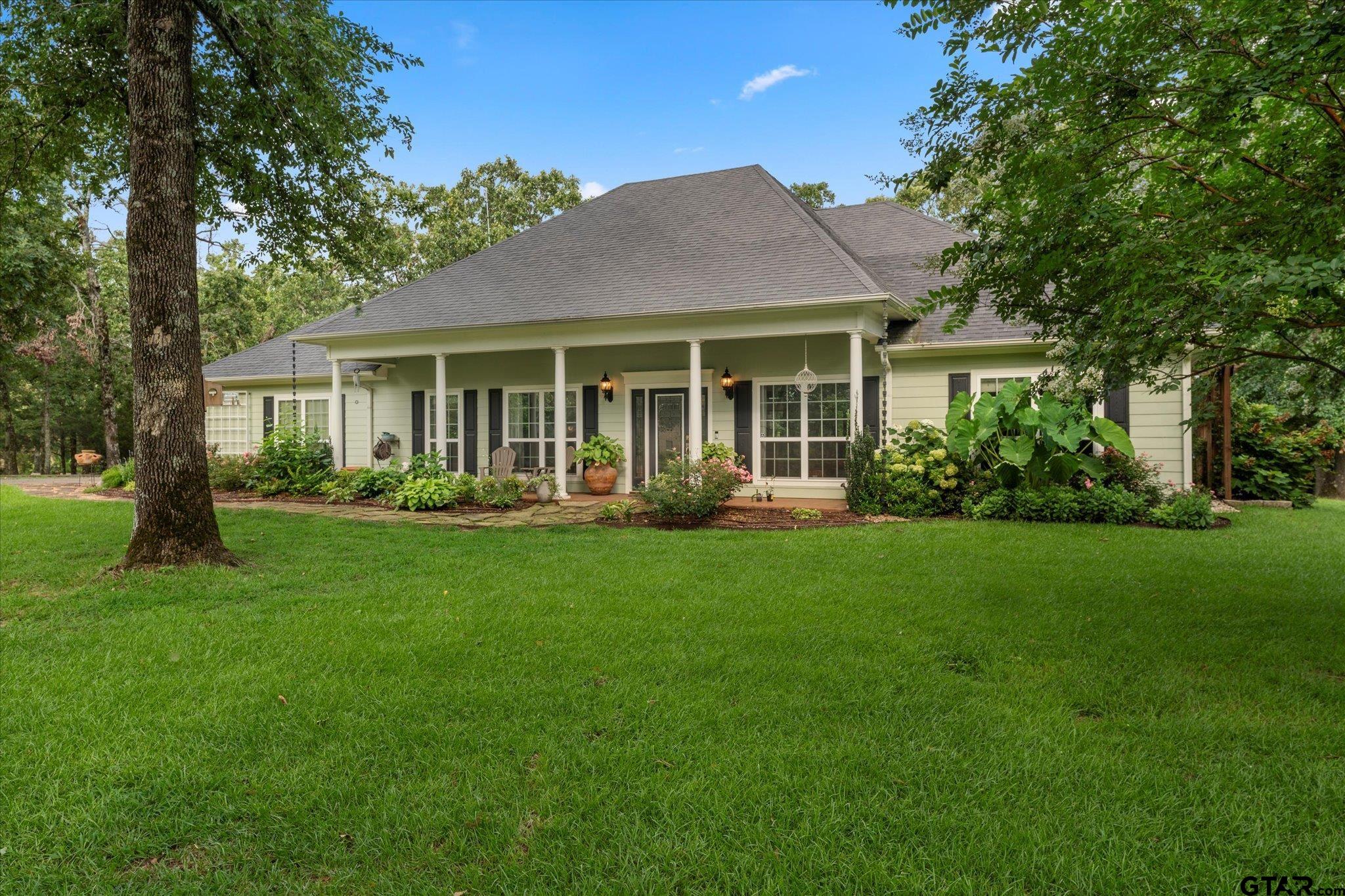 a front view of house with yard and green space