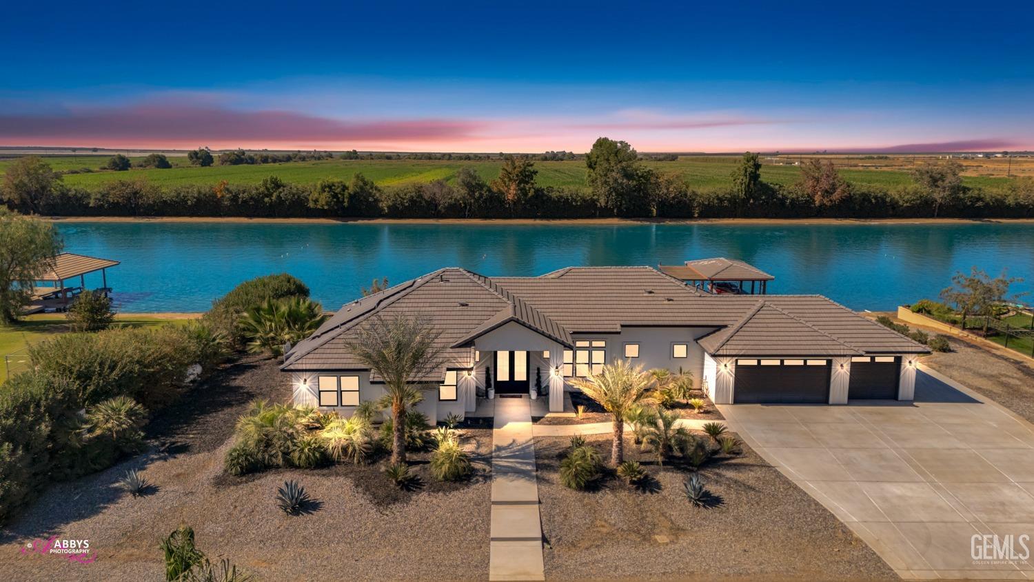 an aerial view of a house with outdoor space and lake view