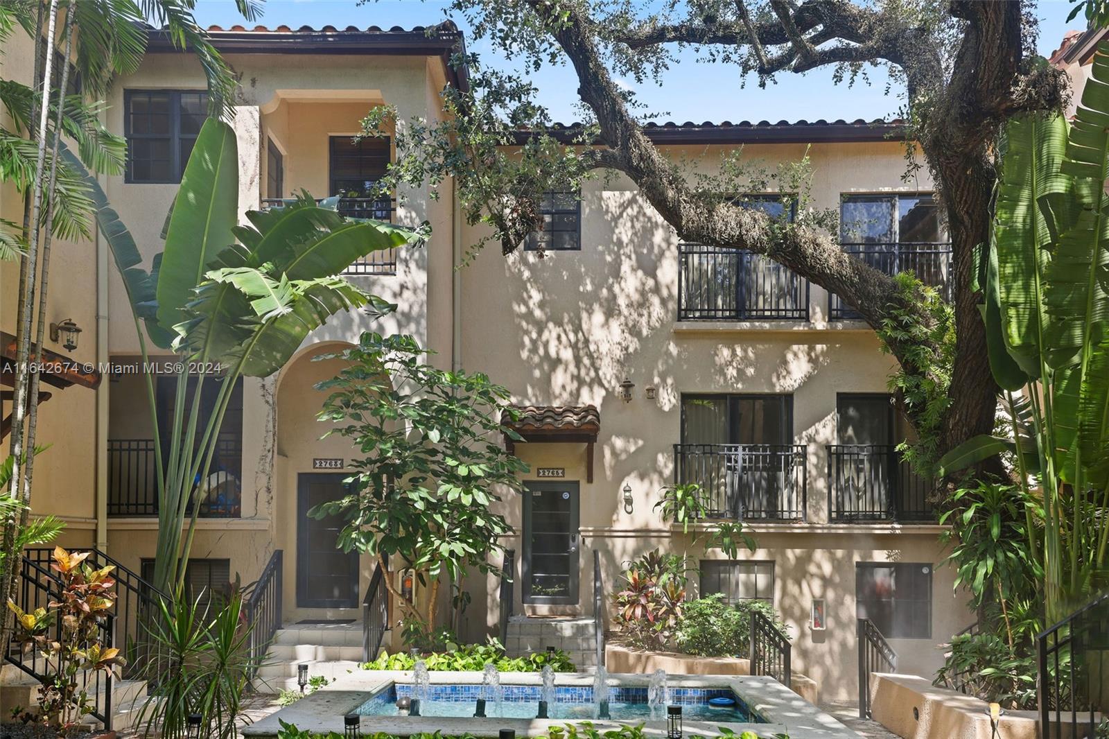 front view of house with a tree in front