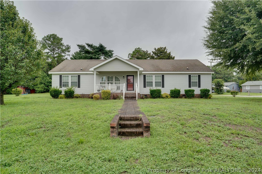 a front view of a house with a yard