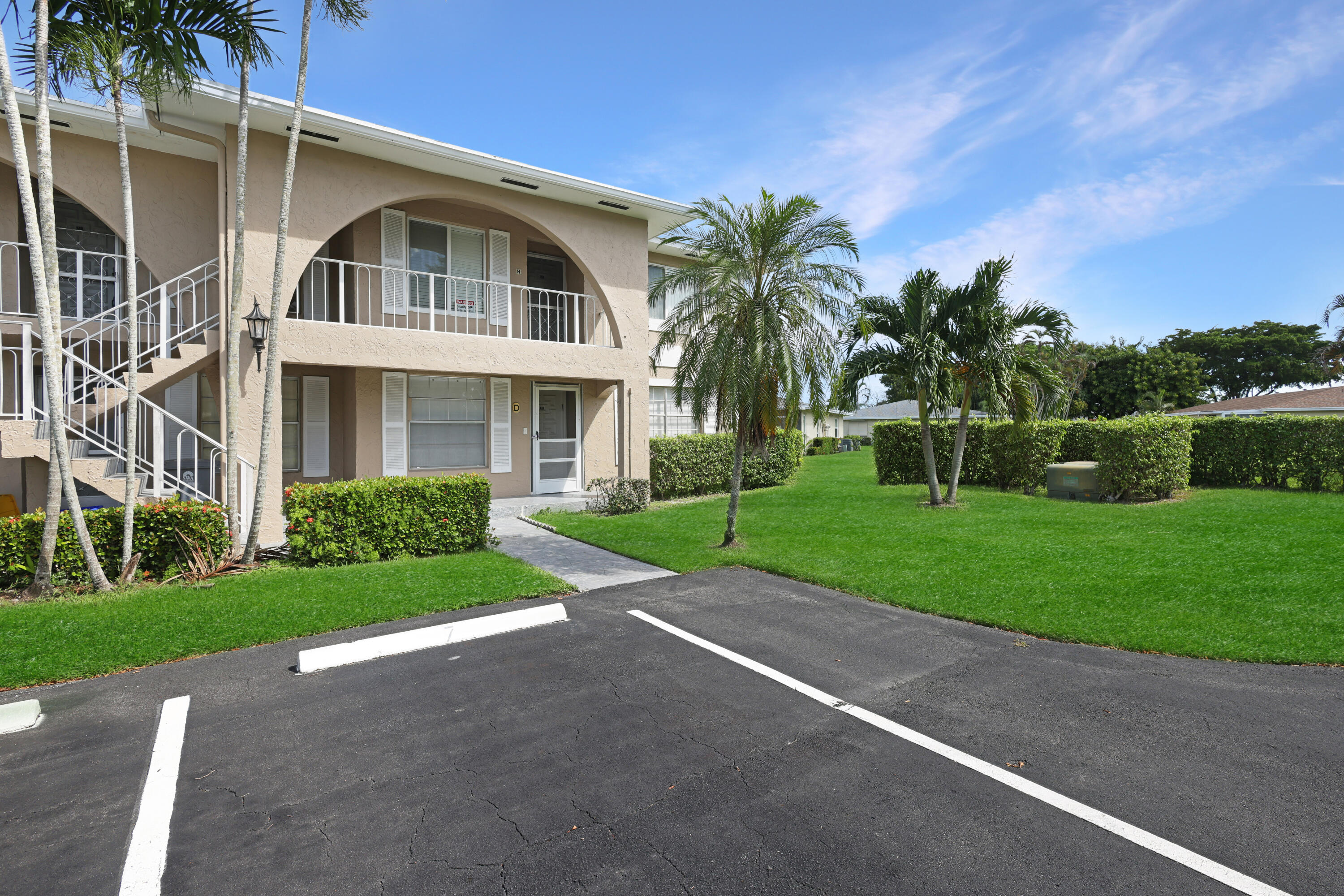 a front view of a house with a yard and trees