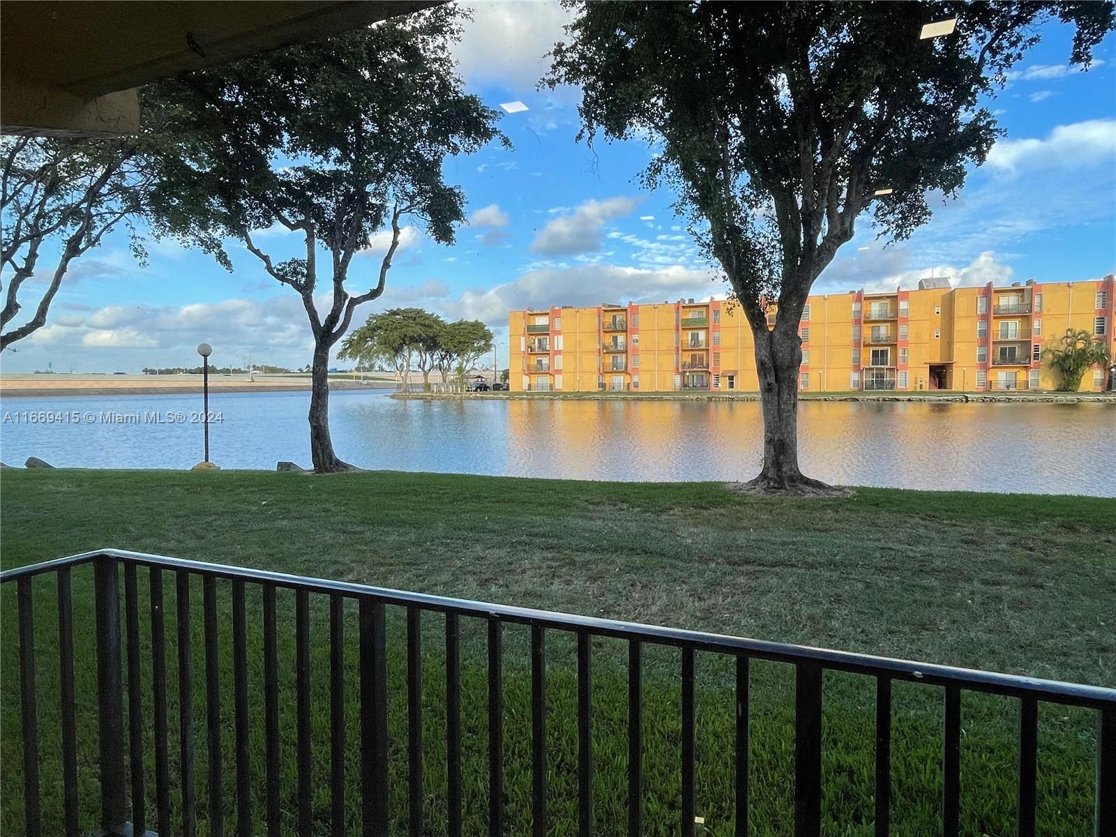 a view of lake with a large trees