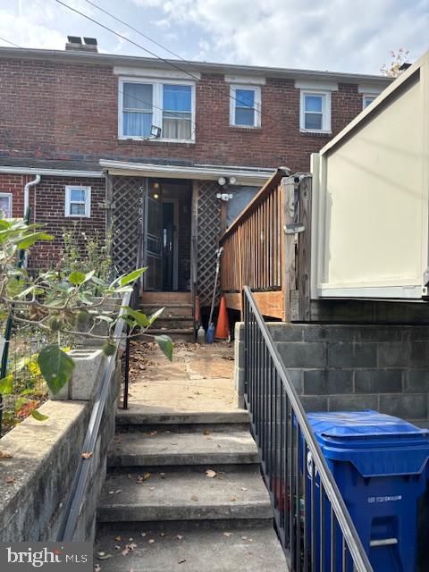 a view of house with outdoor seating and stairs