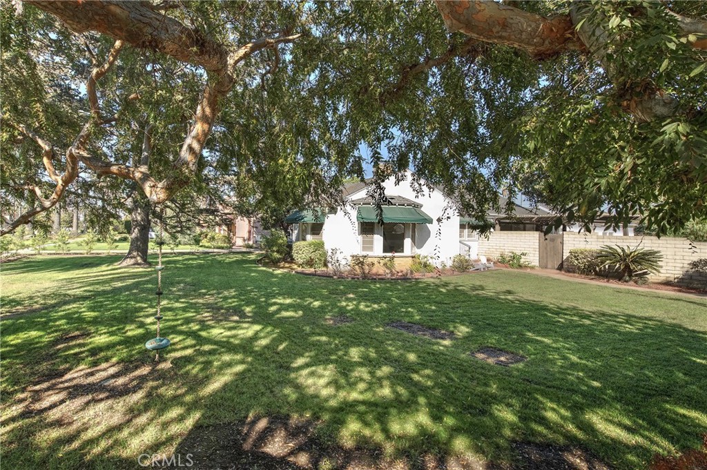 a view of white house with a yard