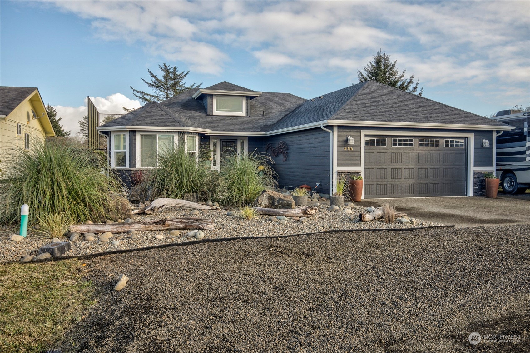 a front view of house with yard and trees around