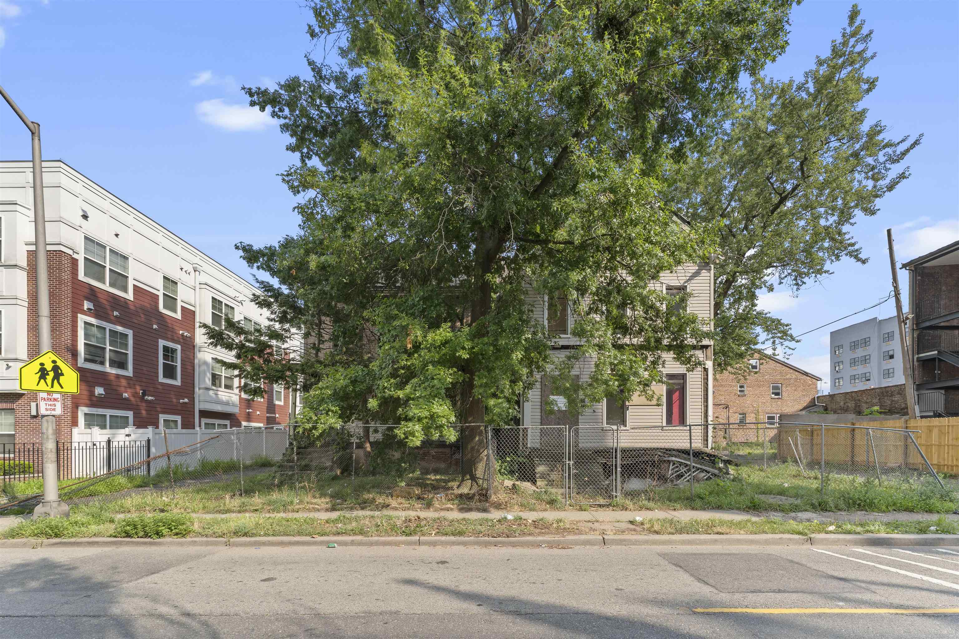 a view of street along with house and trees