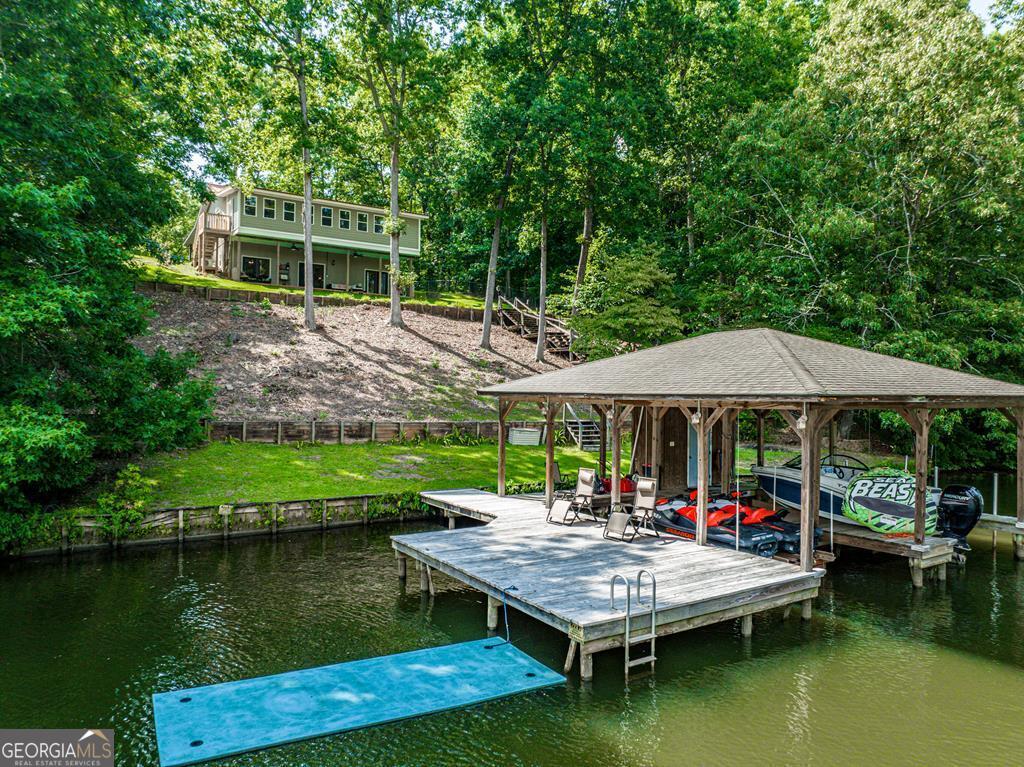 a view of house with outdoor space and lake view