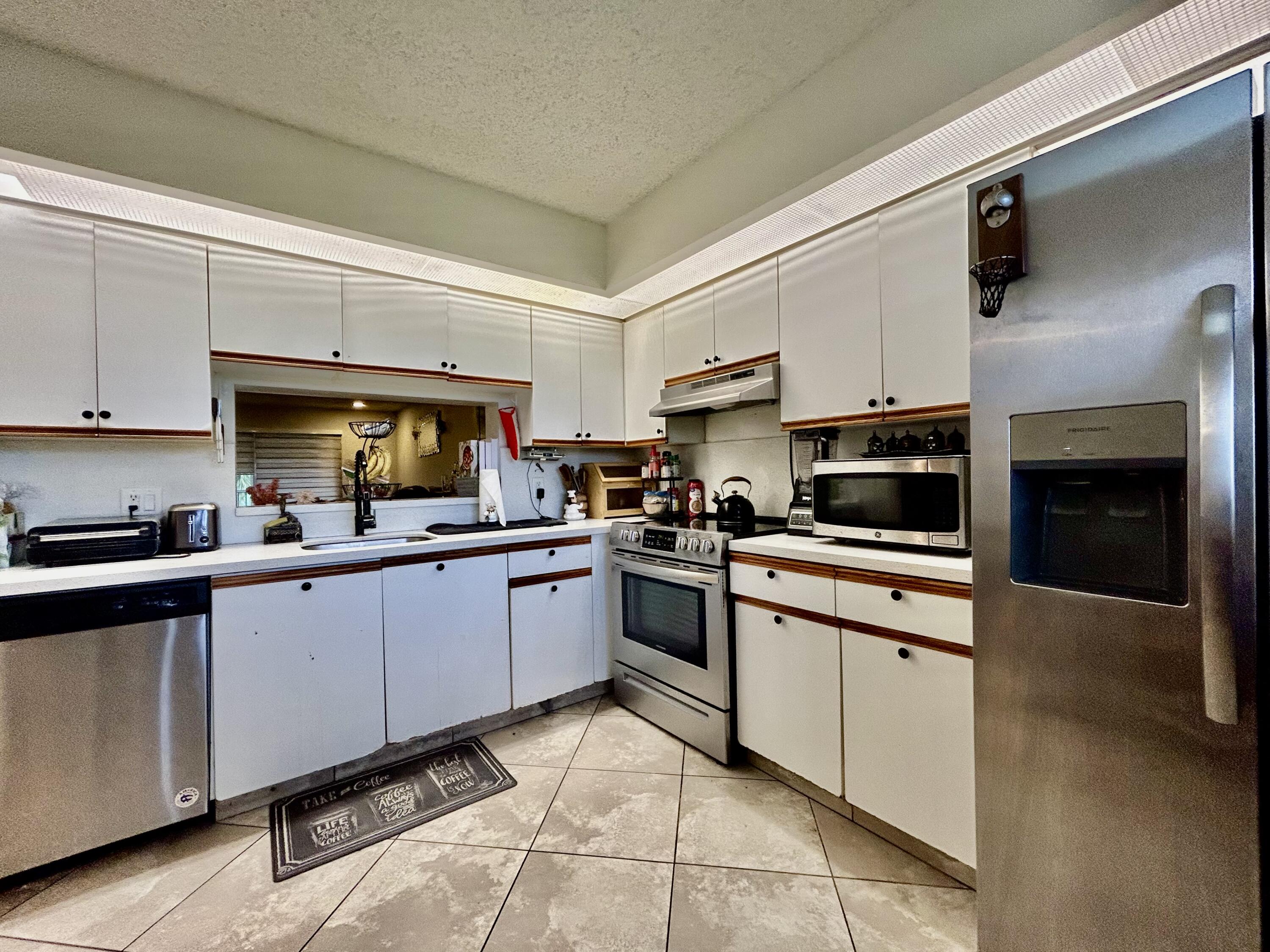 a kitchen with cabinets a sink and appliances