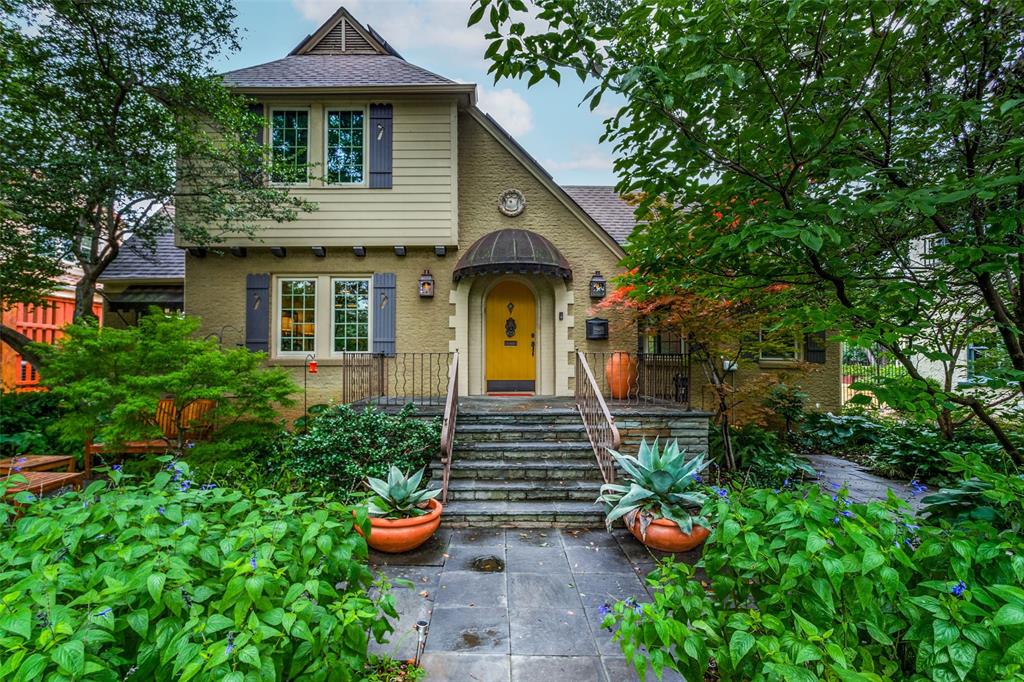 a front view of a house with potted plants