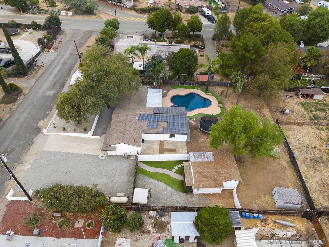 an aerial view of a house with a garden and swimming pool