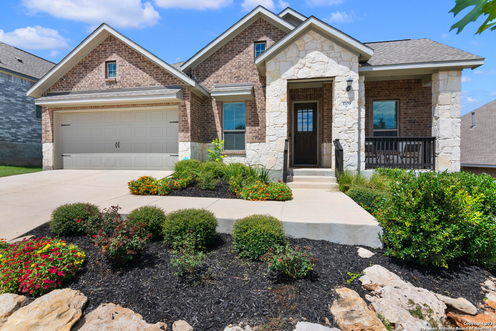 a front view of a house with a yard and garage