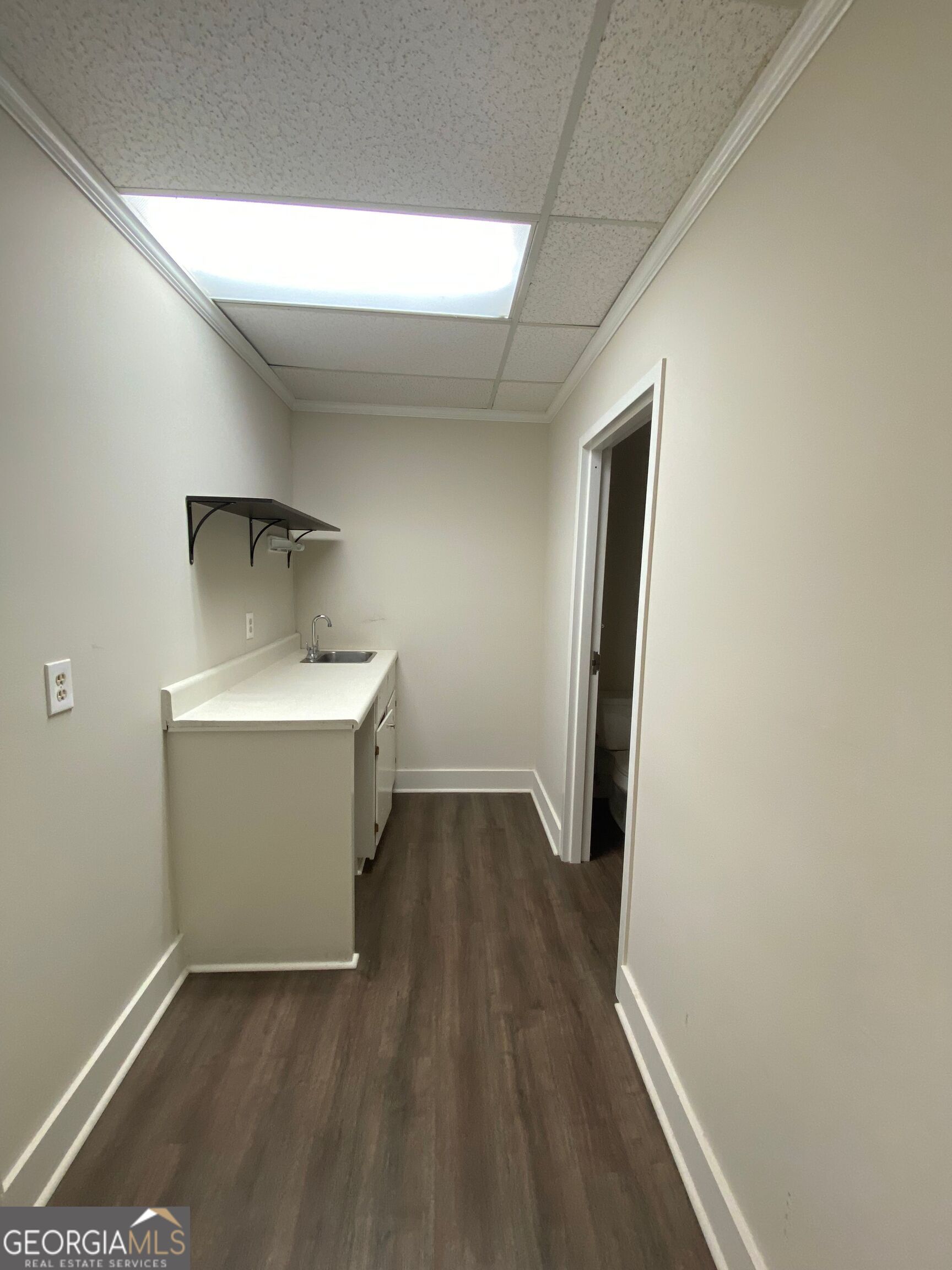 a view of utility room with wooden floor