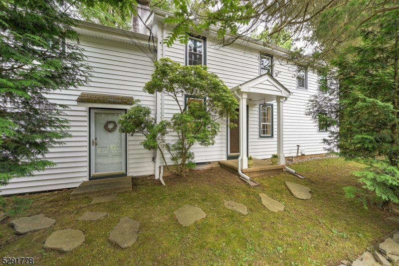 a view of a house with a yard and sitting area