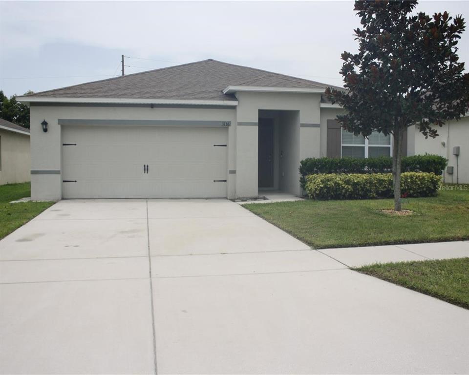 a front view of a house with garage