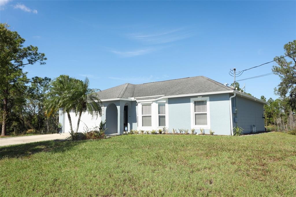 a front view of house with yard and green space