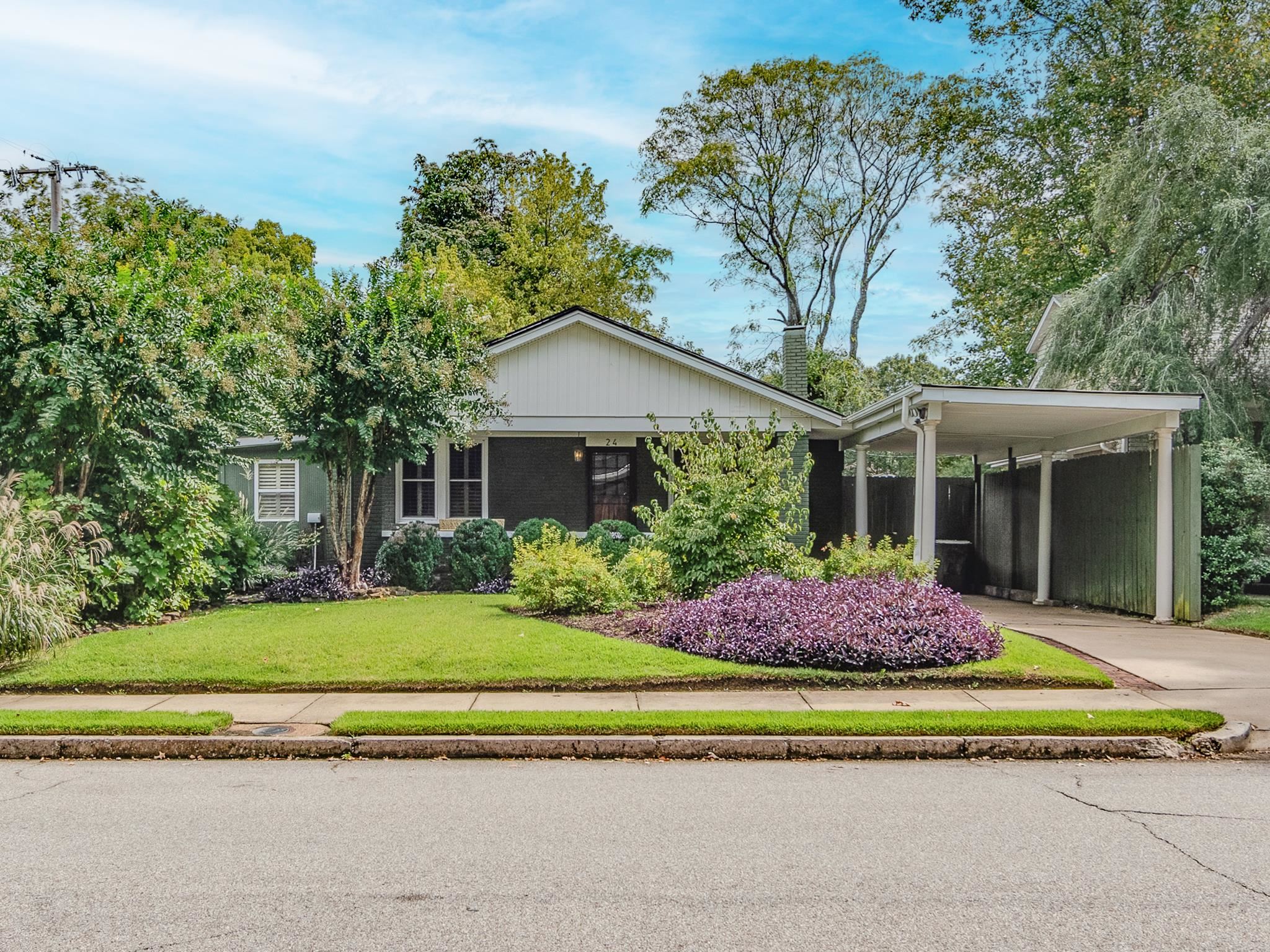 a front view of a house with a garden