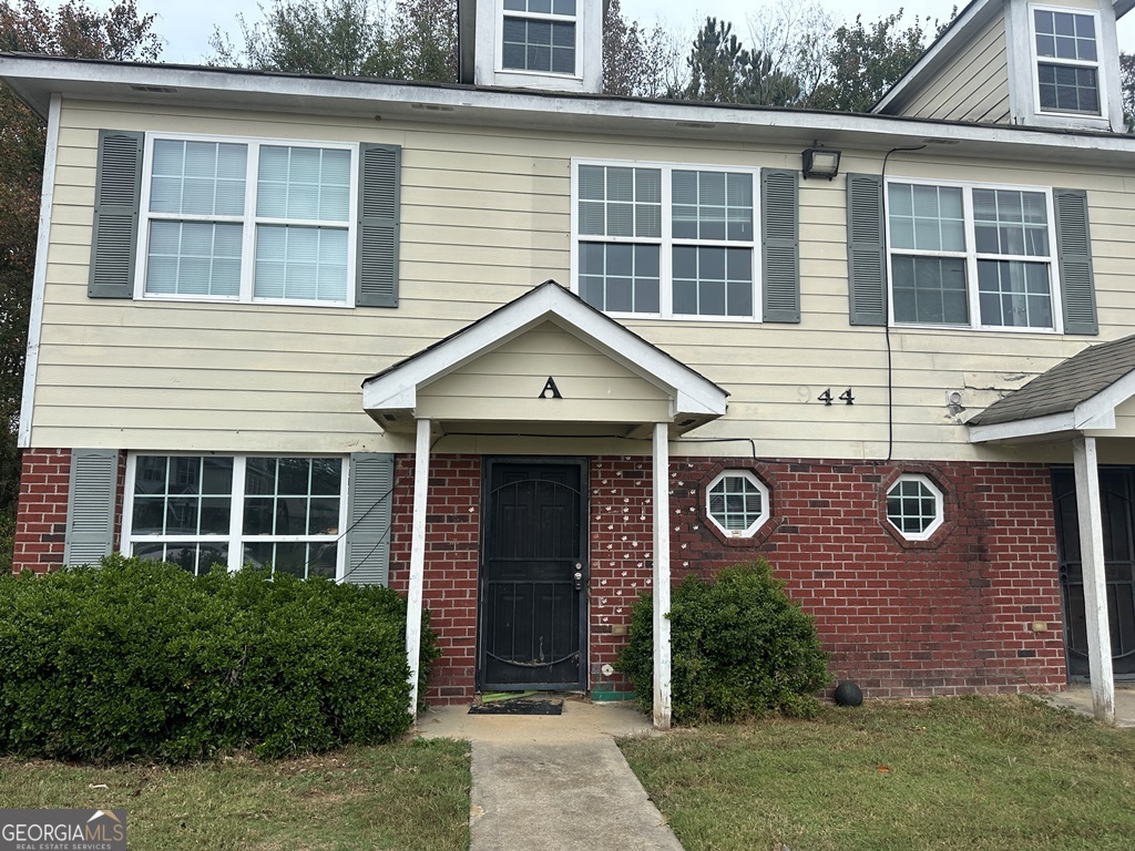 a view of a brick house with a large windows