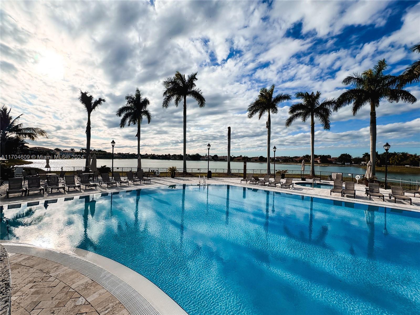 a view of a swimming pool with outdoor seating