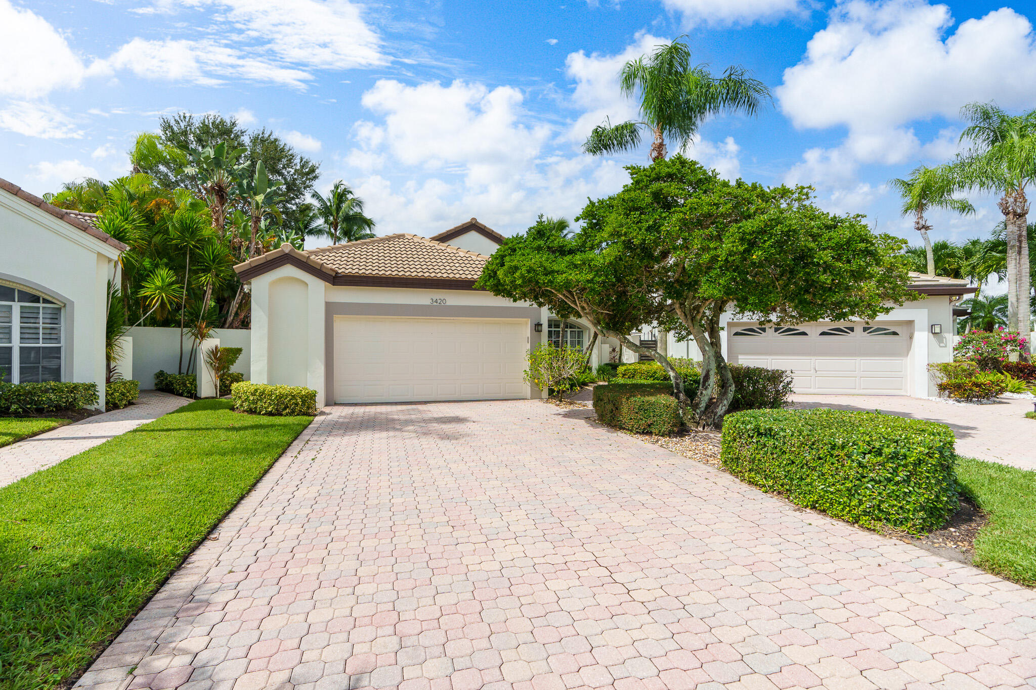 a front view of a house with a yard and a garage