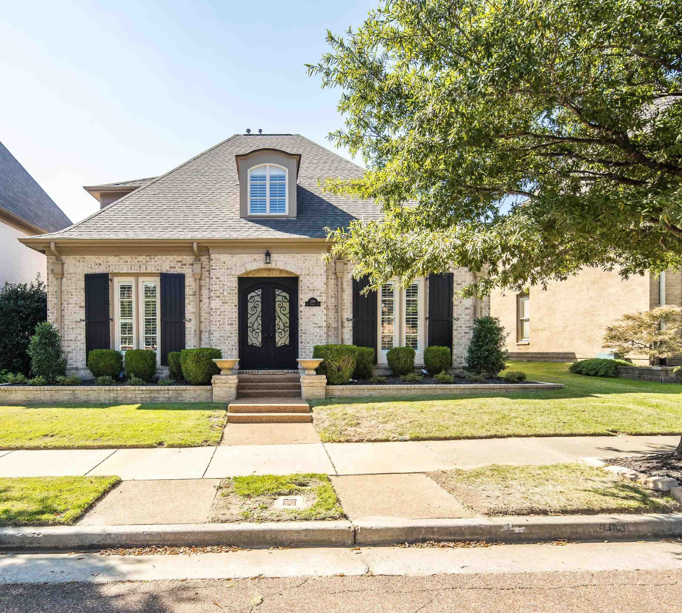 French country inspired facade featuring a front yard