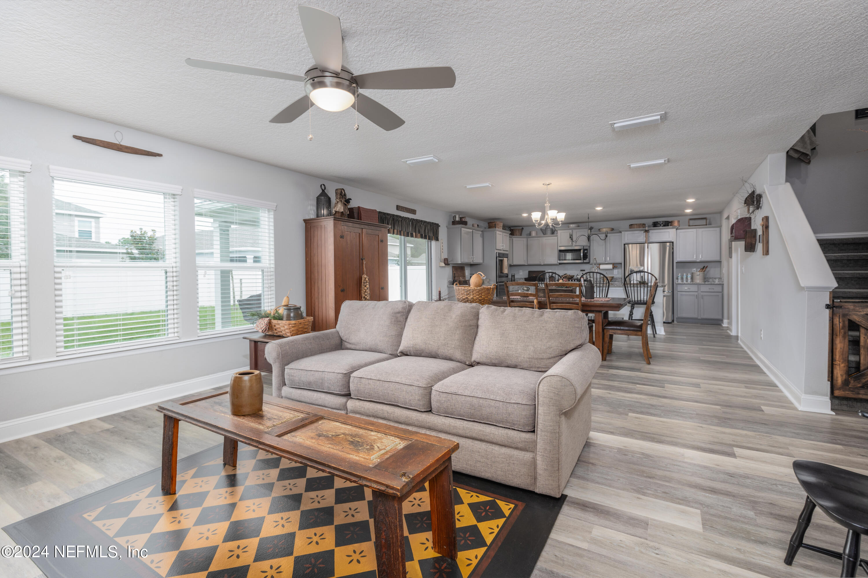 a living room with furniture and kitchen view