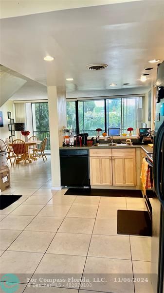 a kitchen with granite countertop a stove a sink and a refrigerator