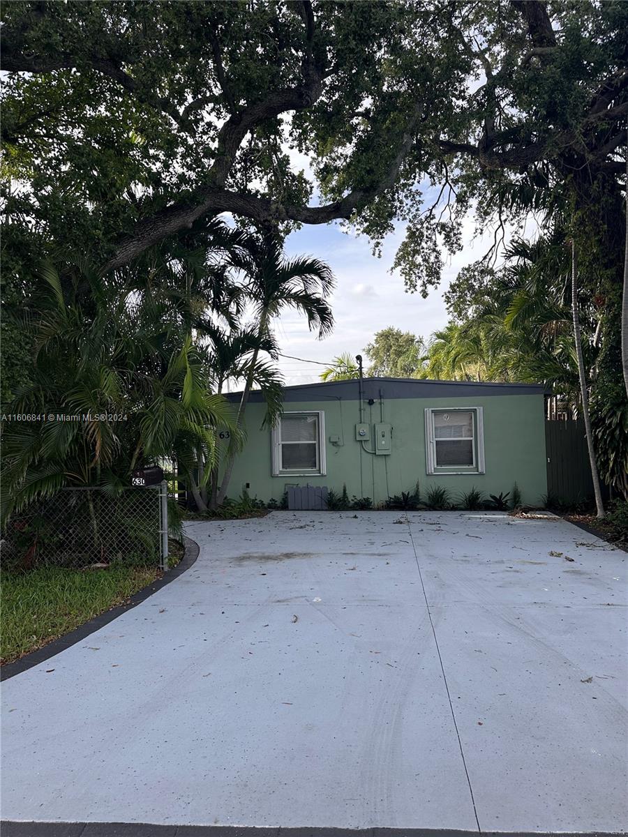 a view of a house with a tree in a yard