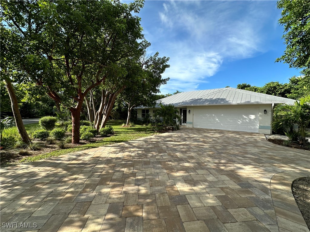 a view of a house with a yard and tree s