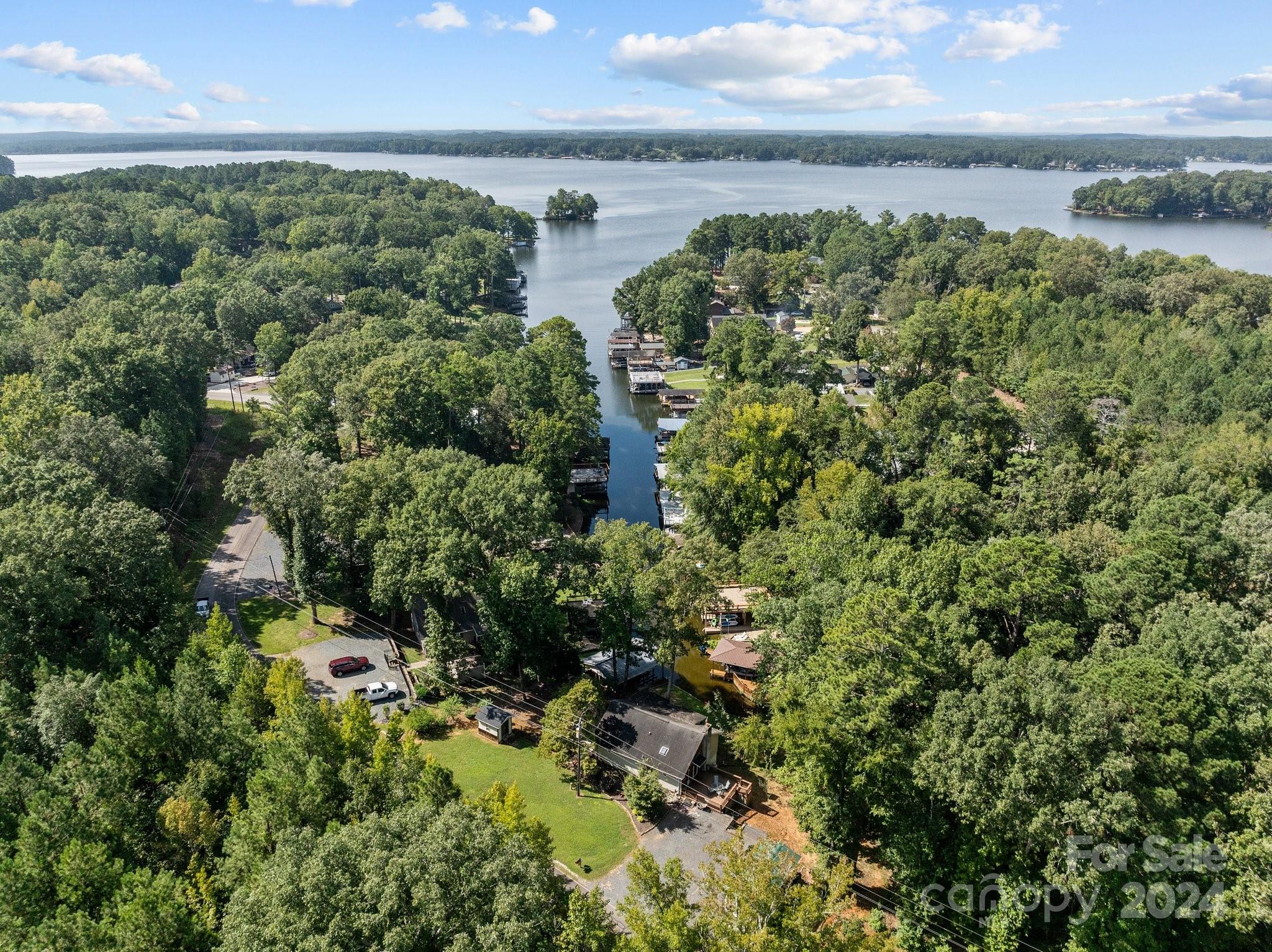 an aerial view of residential house with outdoor space and trees all around