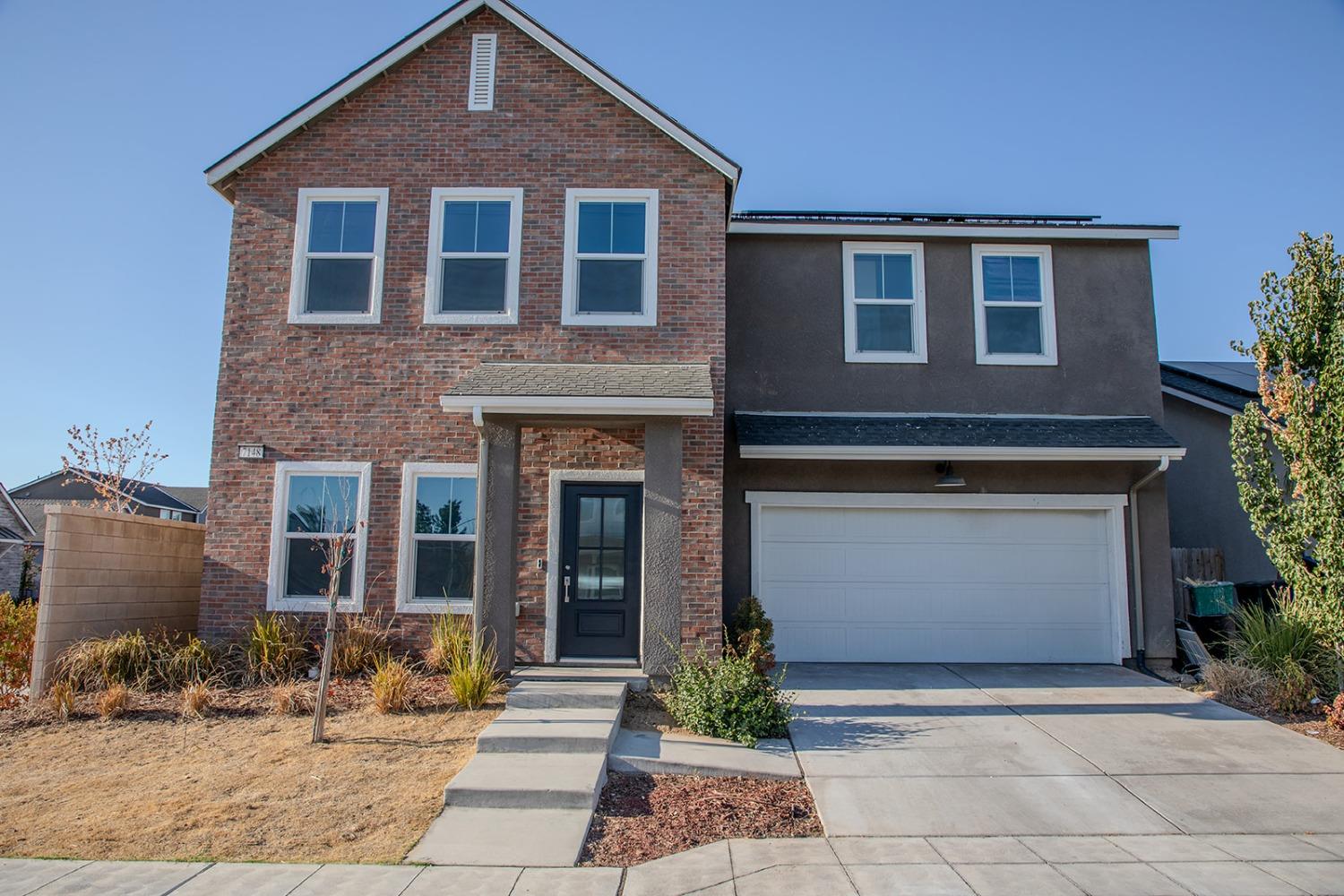 a front view of a house with yard