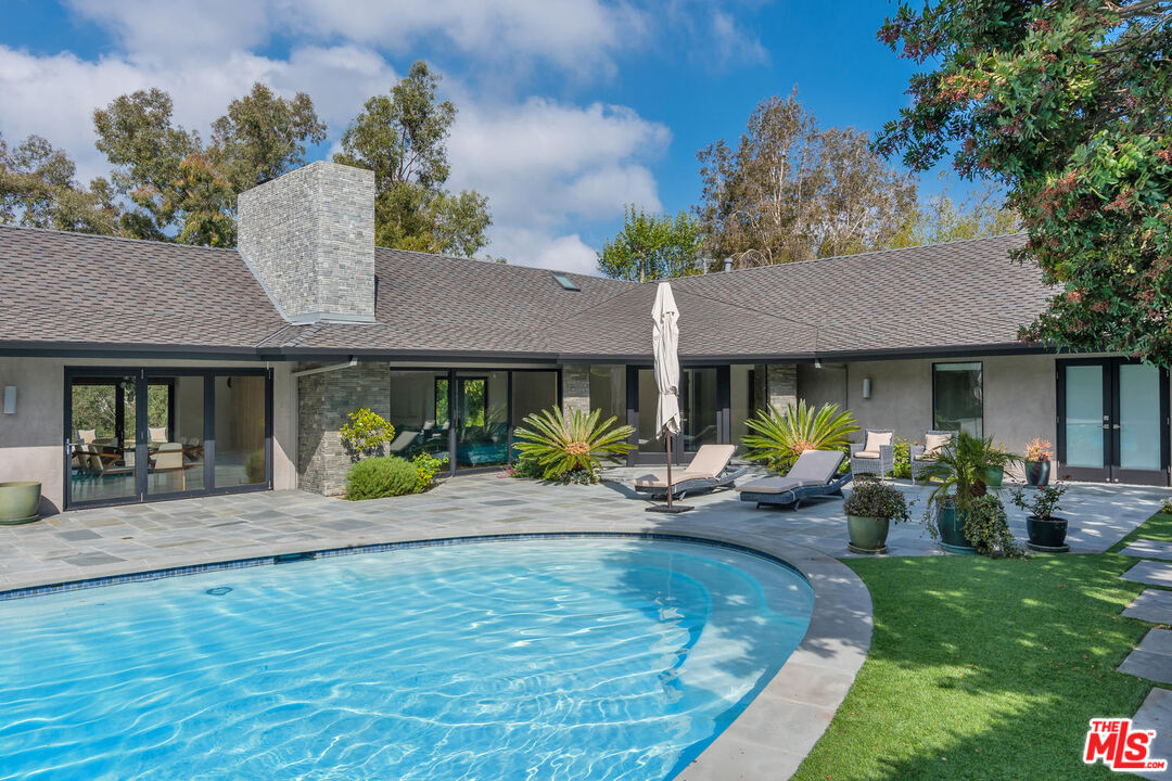 a front view of house with yard and outdoor seating