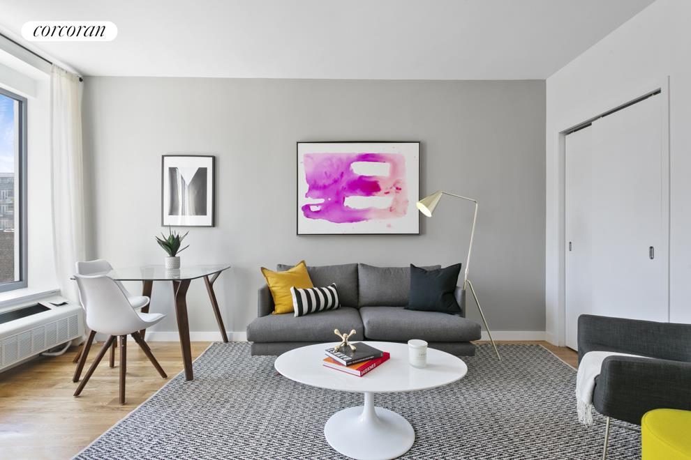 a living room with furniture and a dining table with chair