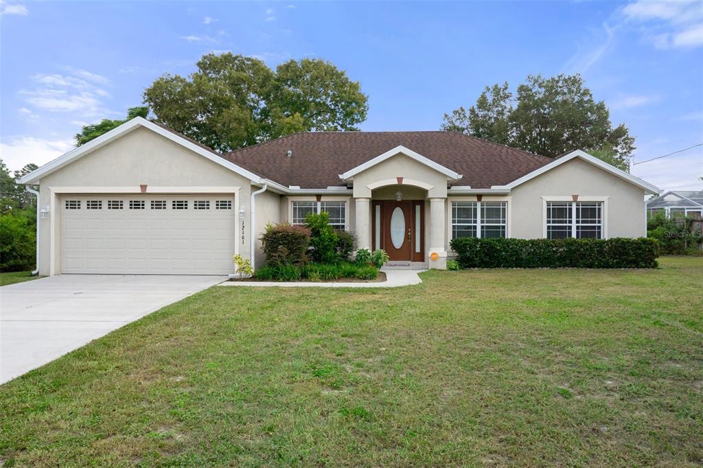 a front view of a house with a garden