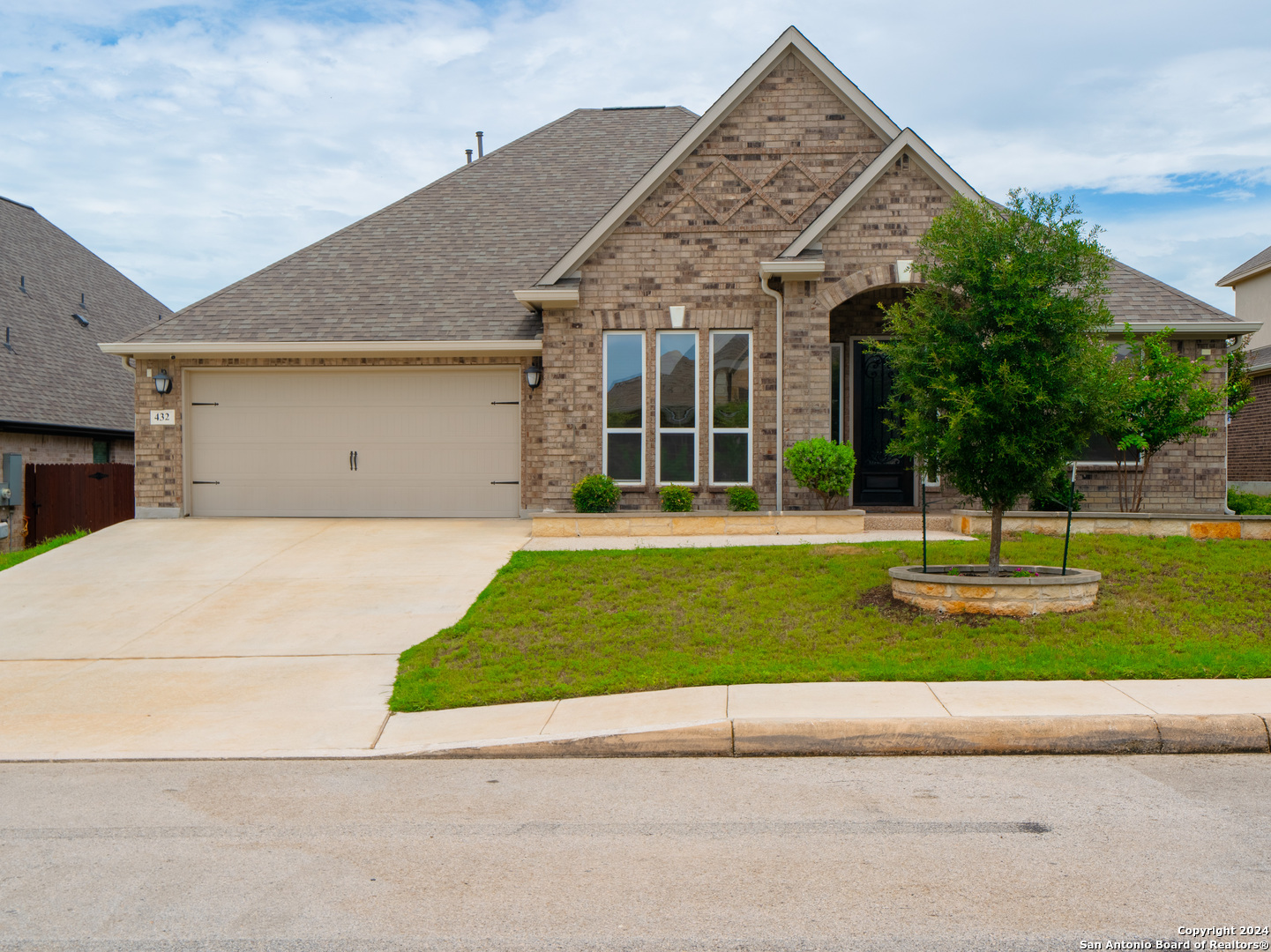 a front view of a house with a yard and garage