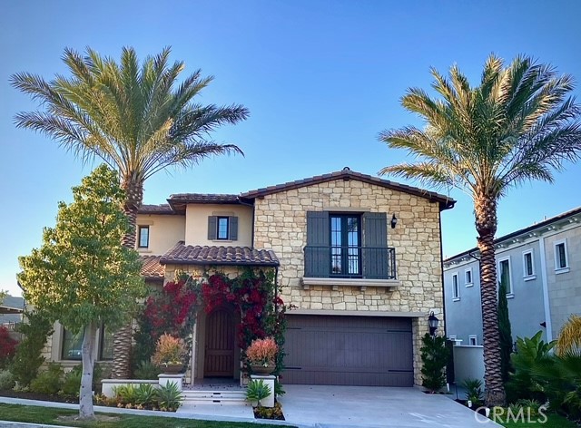 a front view of a house with a tree