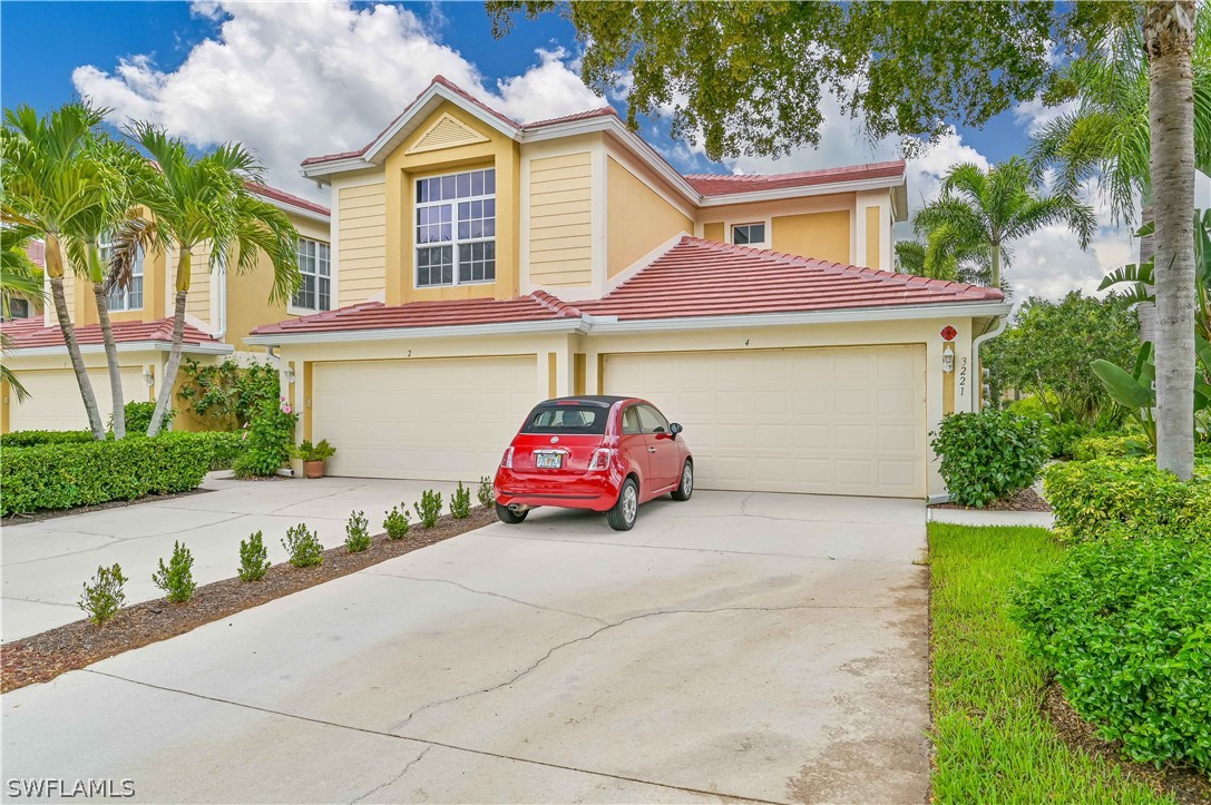 a front view of a house with a garage and outdoor seating