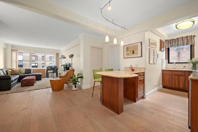 a large living room with stainless steel appliances kitchen island granite countertop furniture and a kitchen view