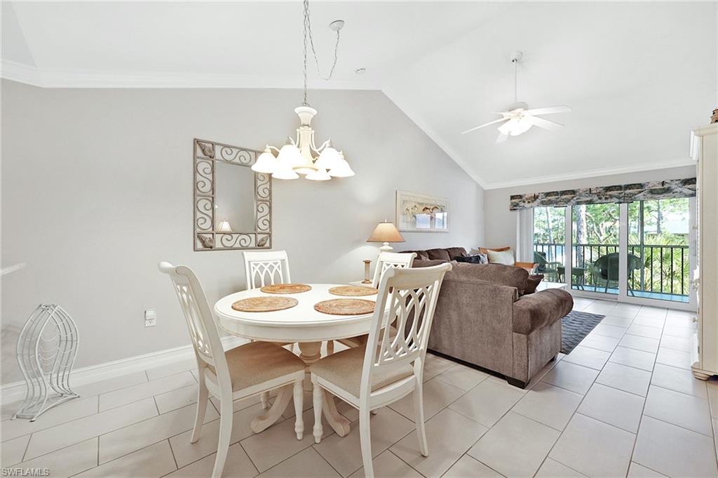 a living room with furniture a chandelier and a table