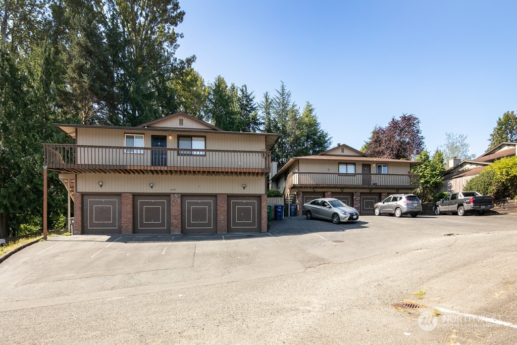 a front view of a house with a yard and parking space