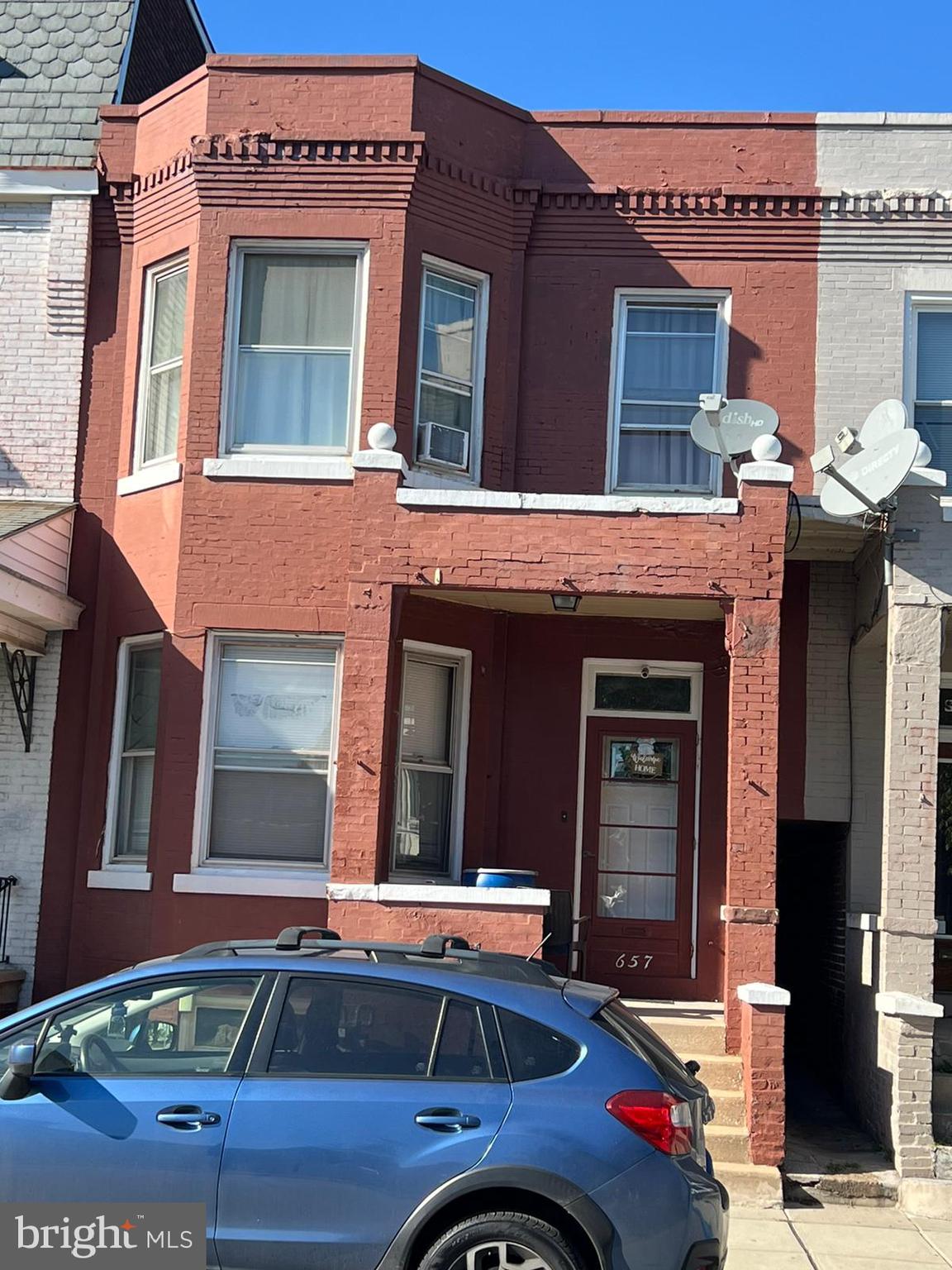 a front view of a house with parking space