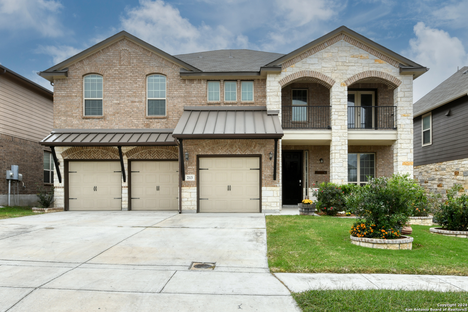 a front view of a house with a yard and garage