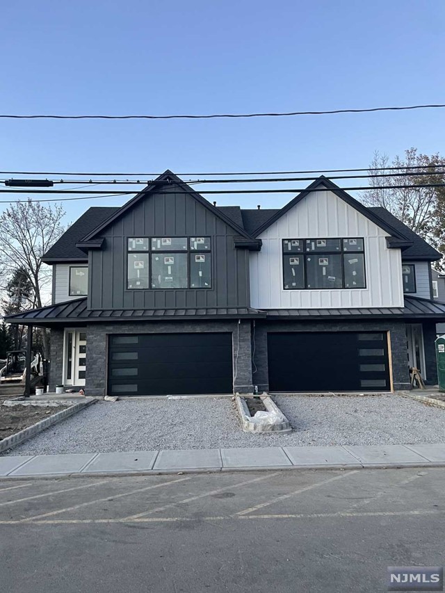 a front view of a house with a large parking space