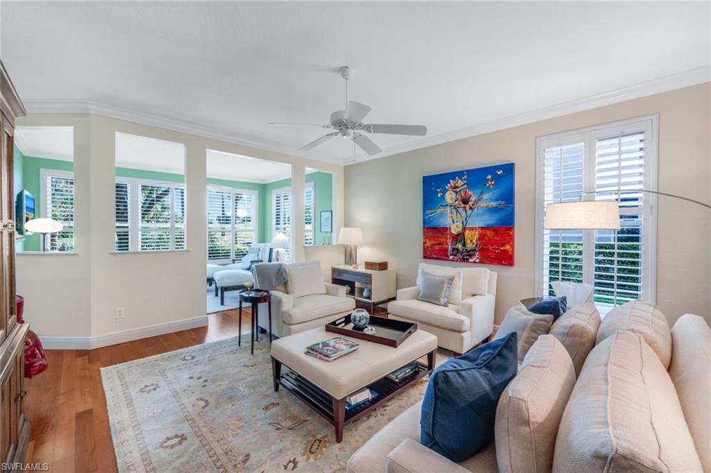 a living room with furniture a rug and a chandelier