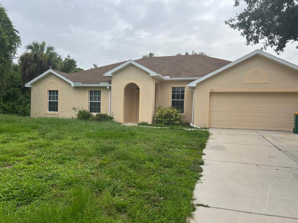 a front view of house with yard and green space