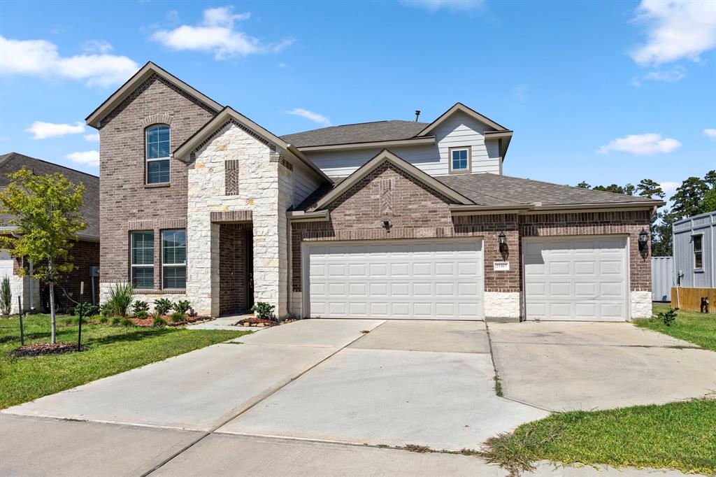 a front view of a house with a yard and garage