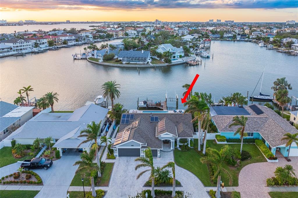 an aerial view of house with yard and lake view