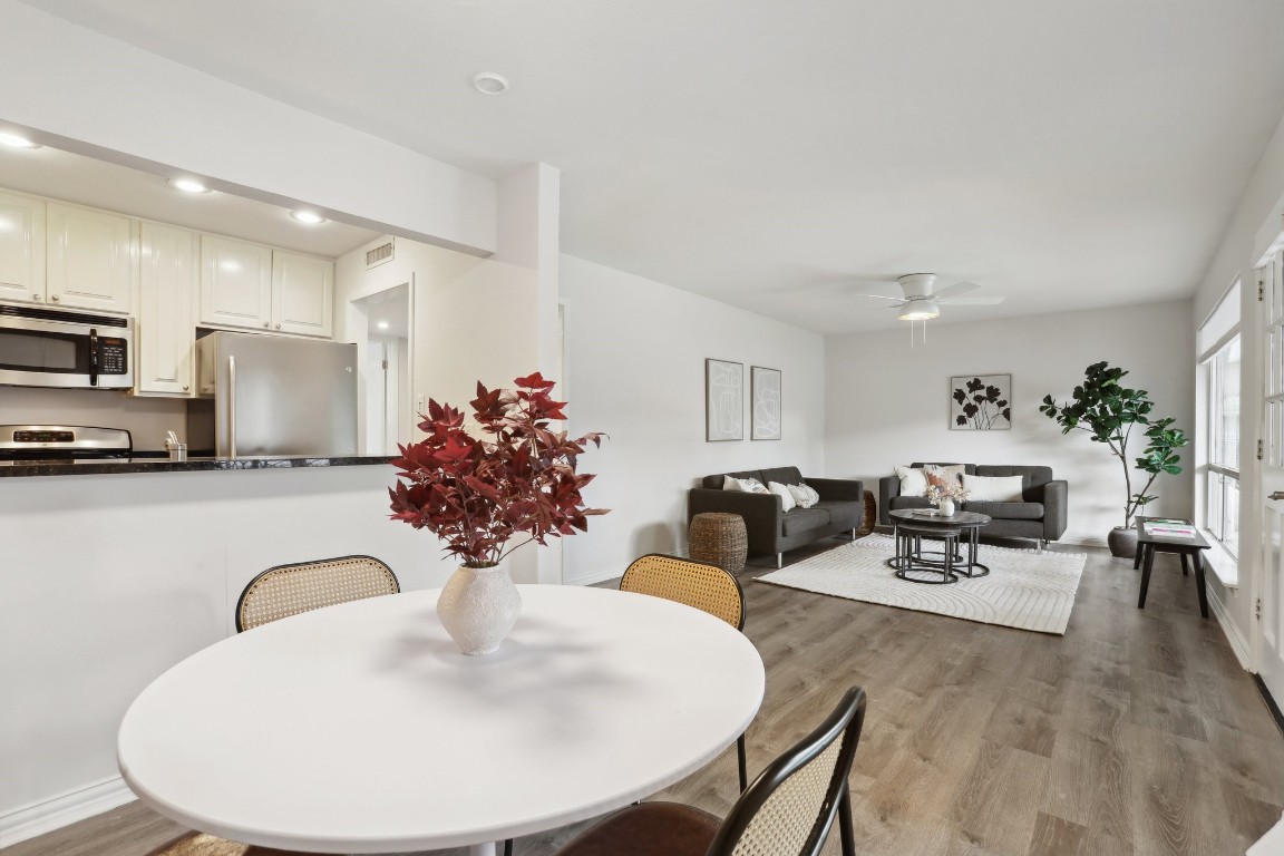 a view of a dining room with furniture and wooden floor