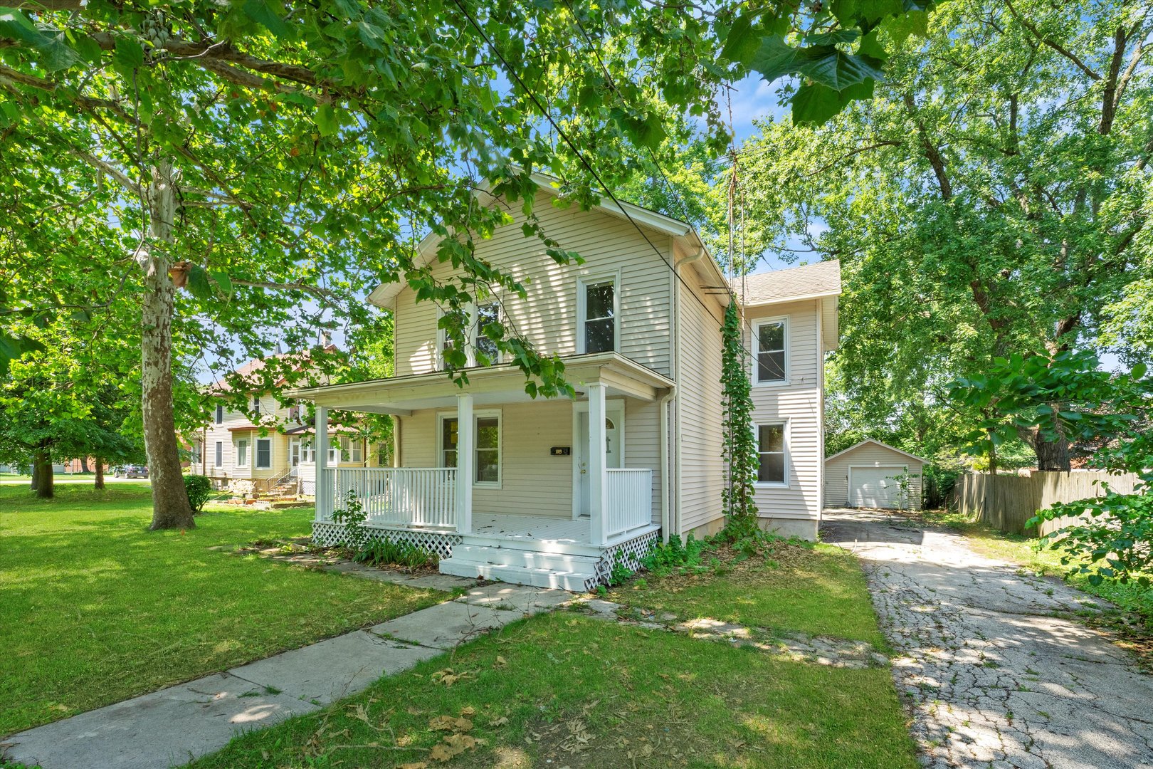 a front view of house with yard and green space