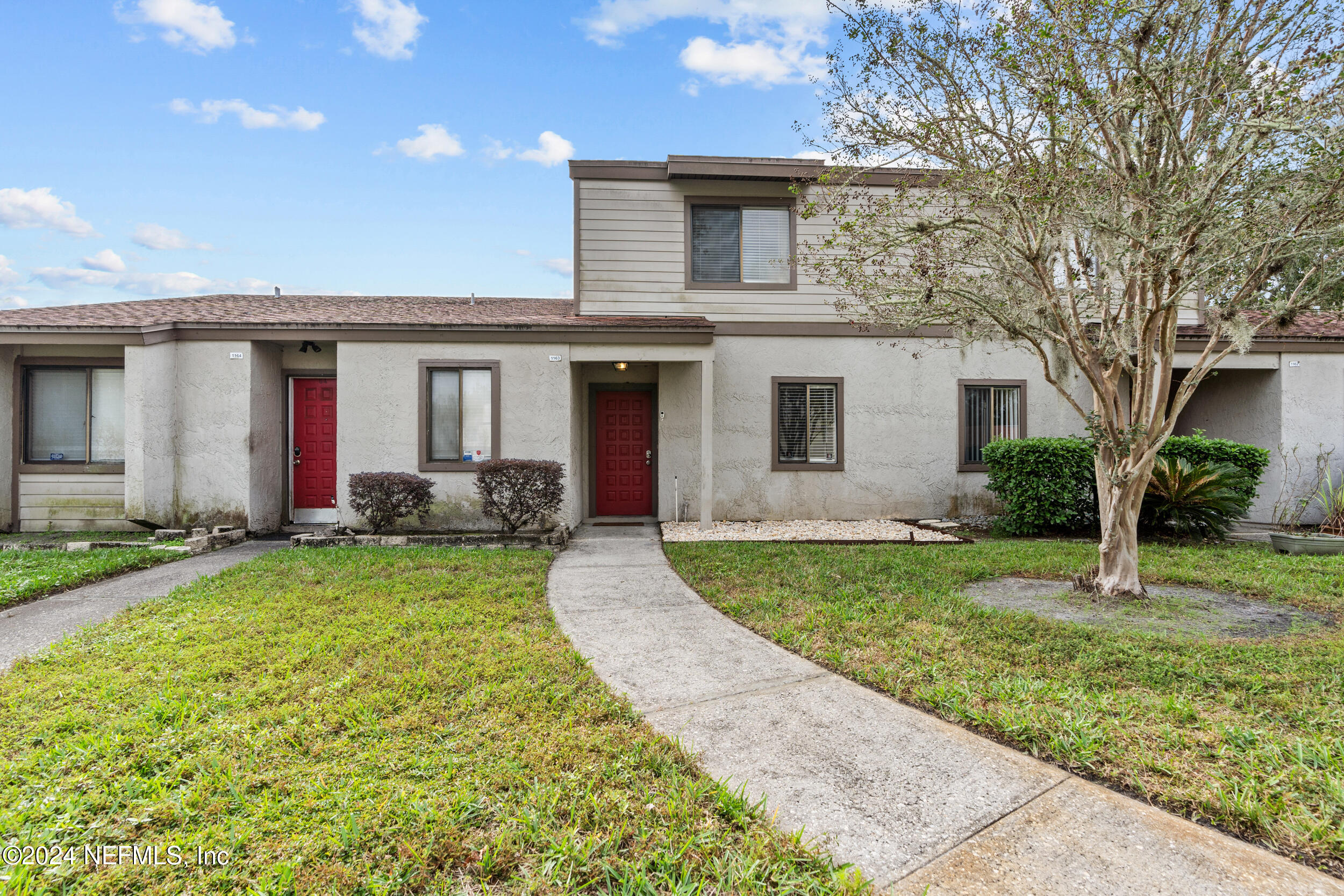 a front view of house with yard and green space